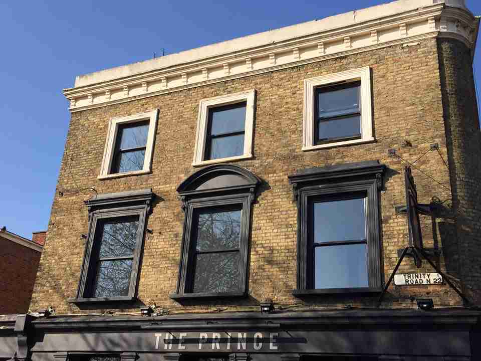 Black uPVC Vertical Sliding Windows on a traditional brick building Bristol