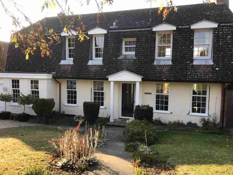 uPVC Vertical Sliding Windows in a black and white house Bristol