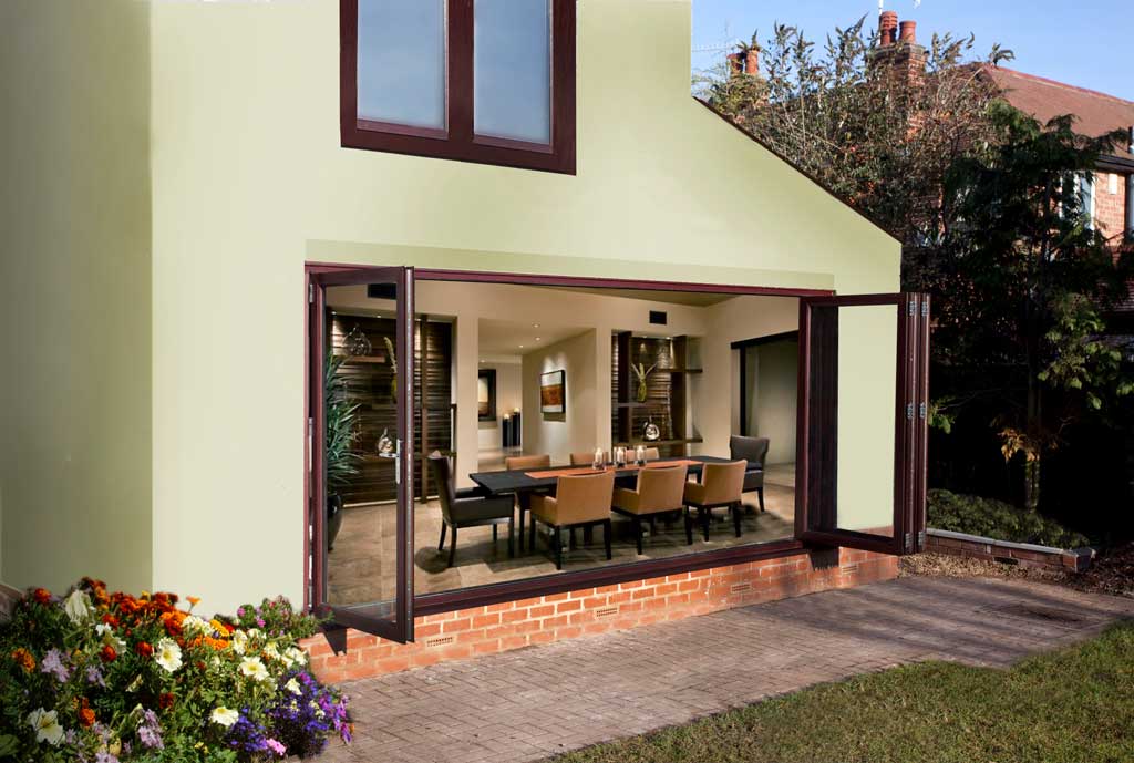 Green house with dark brown woodgrain foiled uPVC bifold doors that are open