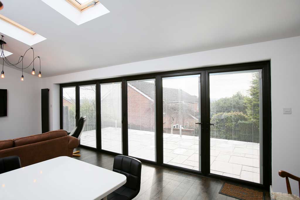 black closed aluminium bifold doors in a dining room