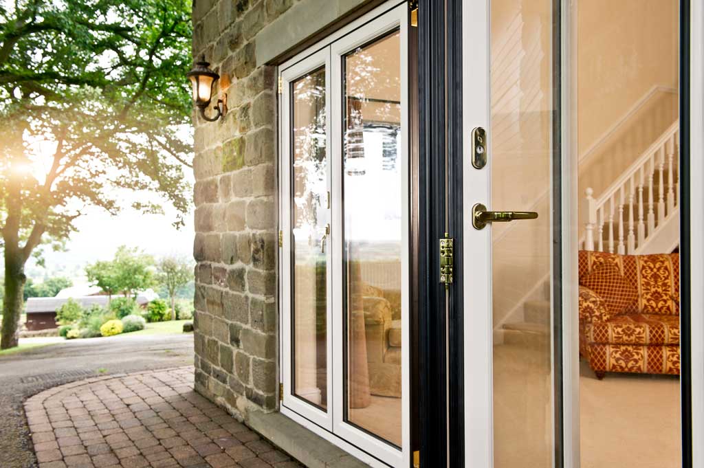 White aluminium bifold doors on a traditional brick building in Bristol