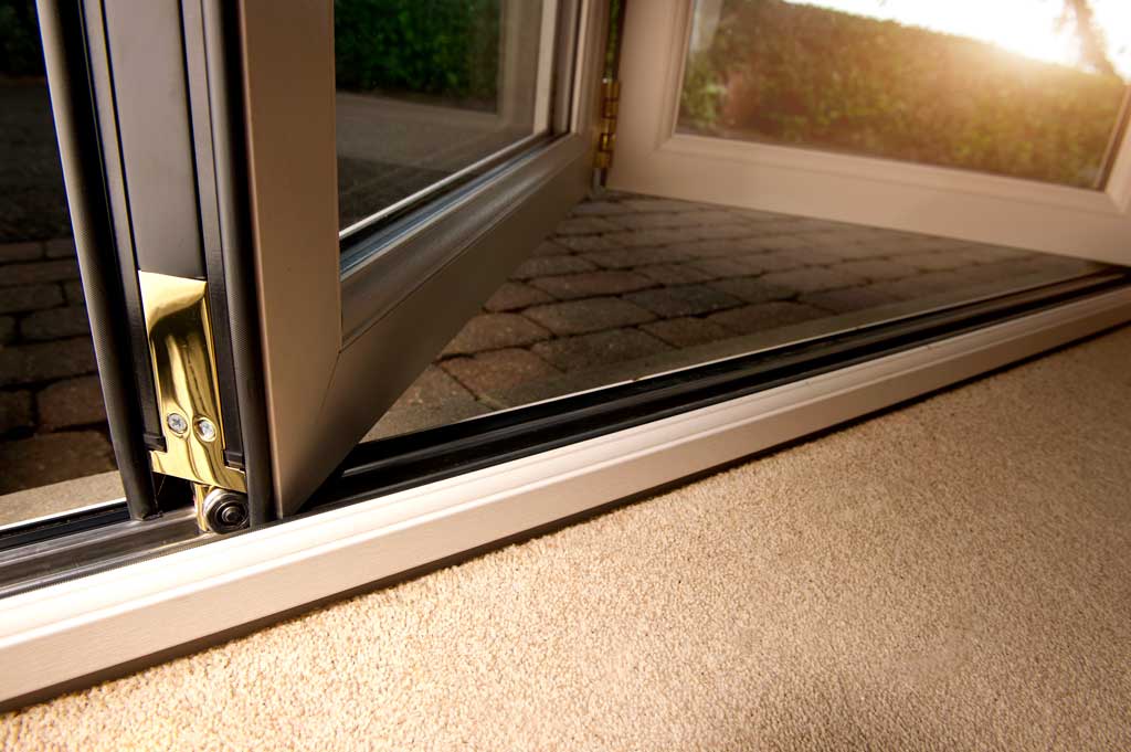 close up of aluminium bifold doors low threshold with doors partially open