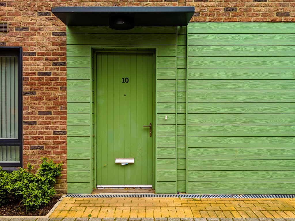 Green Composite Front Doors on a red brick building in Bristol