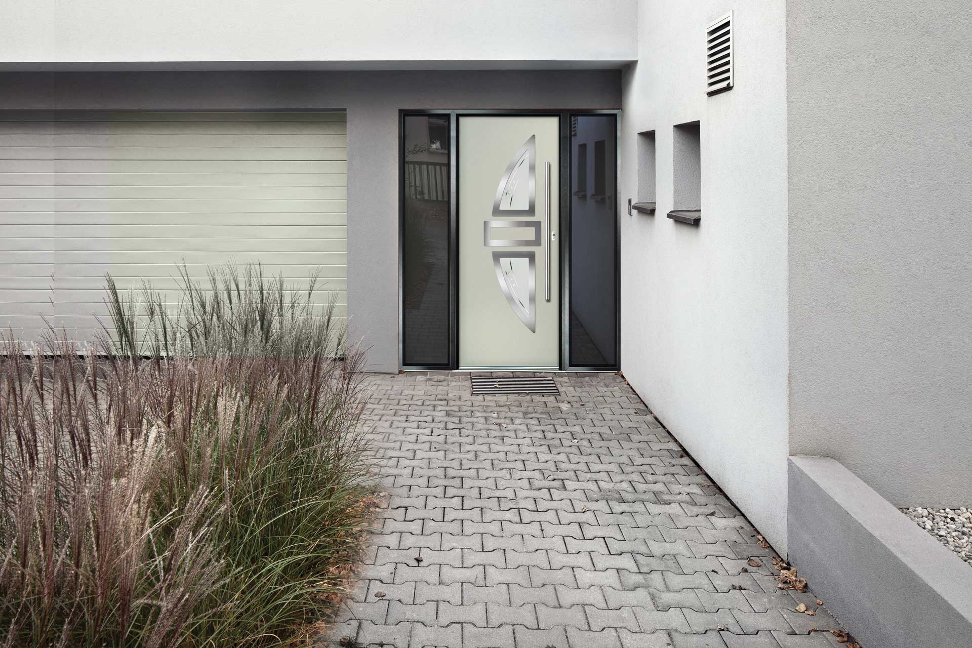 A driveway with a white composite door