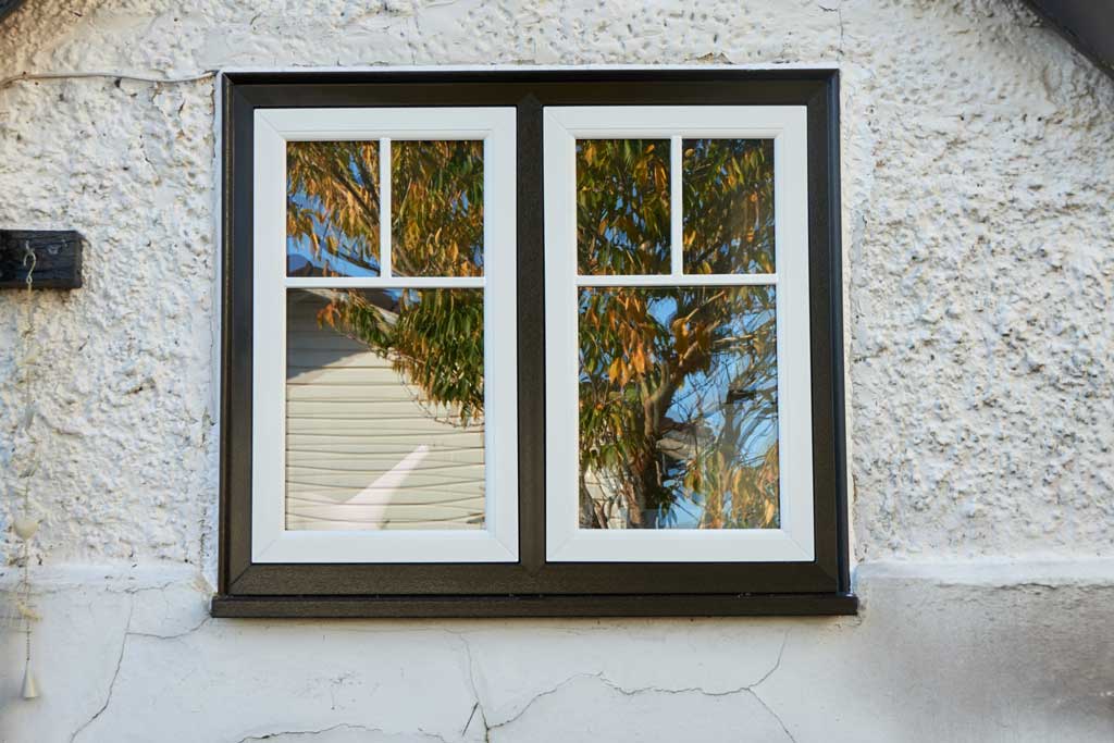 White and Black Double Glazed Windows on a Beige Wall in Swindon