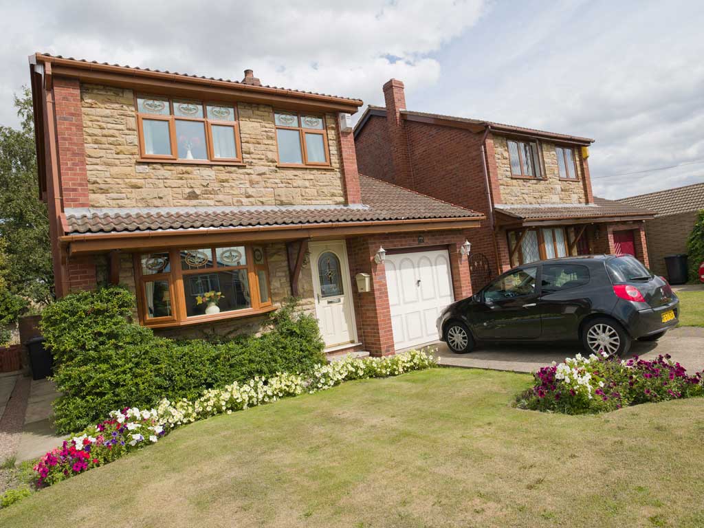 Triple glazed woodgrain foiled windows on a large modern brick home